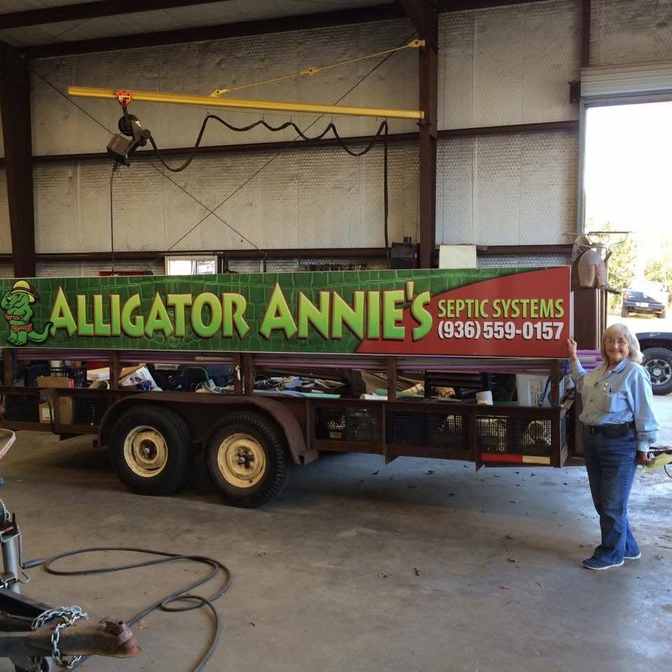 Alma "Alligator Annie" Tippins with her Alligator Annie&rsquo;s Septic Systems trailer